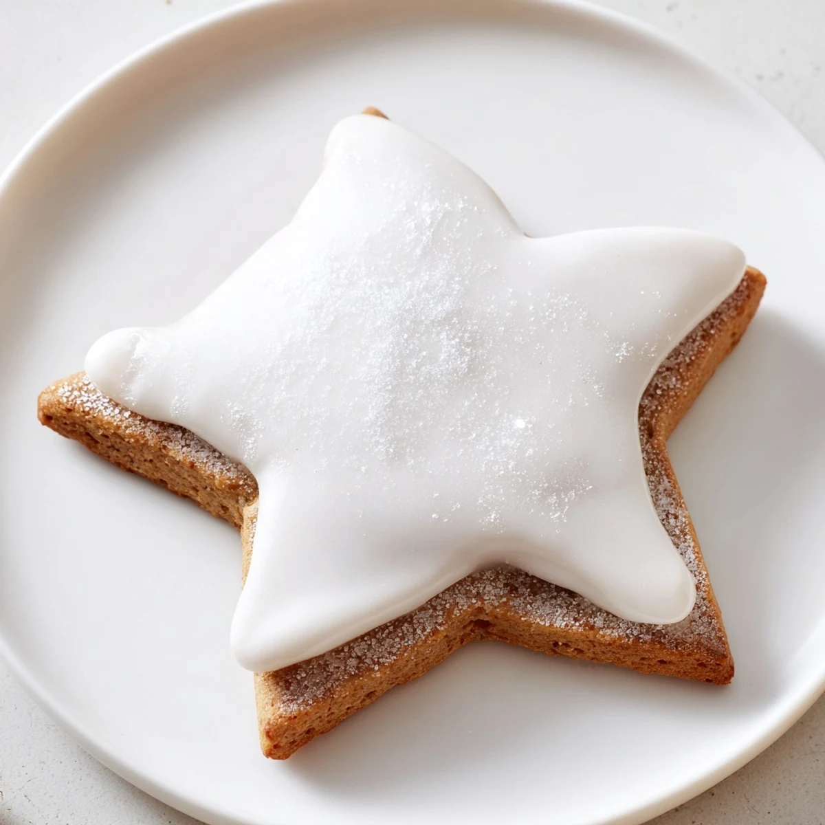 Close-up of golden, star-shaped Cinnamon Stars, ready to be enjoyed with a warm drink.