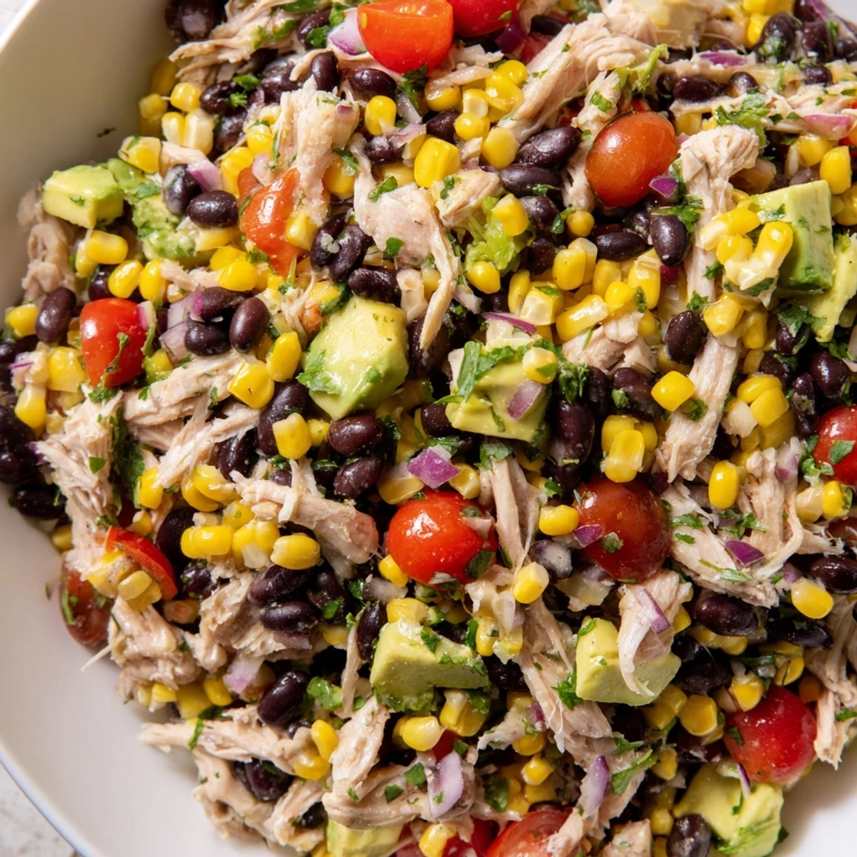 Savory Southwestern Bean Salad with chicken, colorful veggies, and a zesty lime dressing.