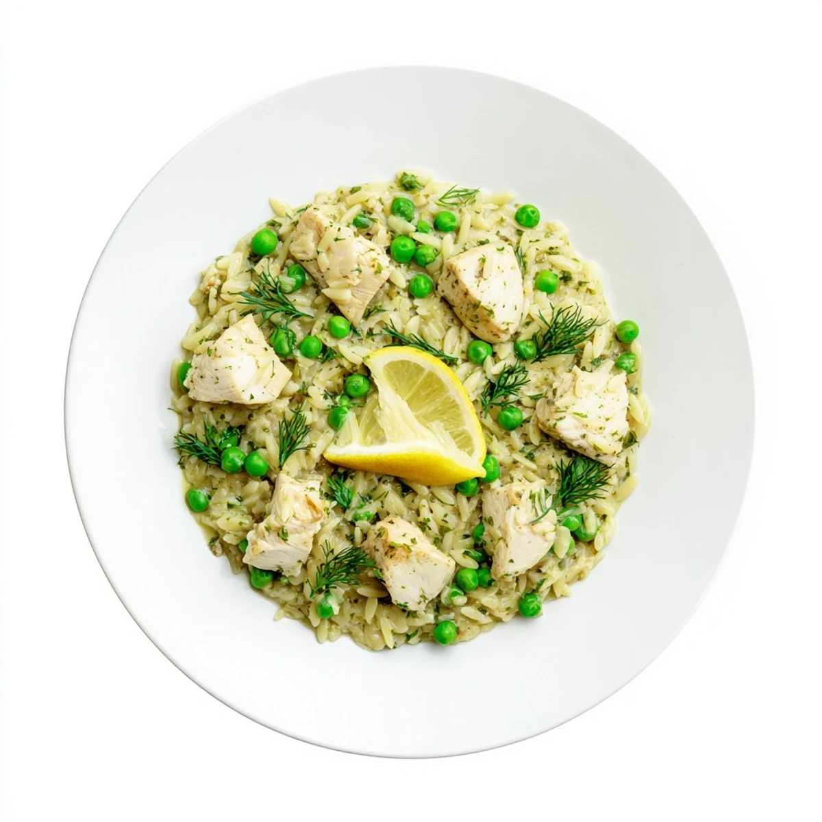 Golden pieces of chicken simmer with orzo, peas, and fresh herbs in a bright lemon sauce in this one-pan skillet dinner.