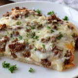 This Ground Beef Alfredo Pizza shows bubbly mozzarella over a rich Alfredo sauce and beef.