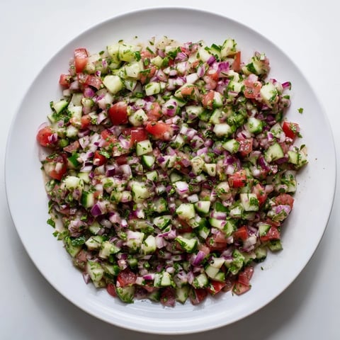 Zesty pickled cucumber pico de gallo: vibrant salsa with diced tomatoes and fresh cilantro.