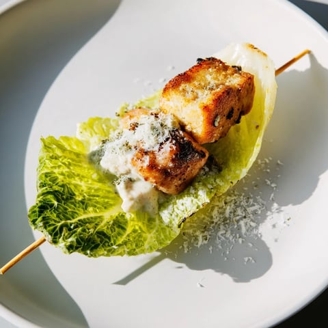 Grilled Chicken Caesar Salad Skewers served with a creamy Caesar dressing, a delightful appetizer.