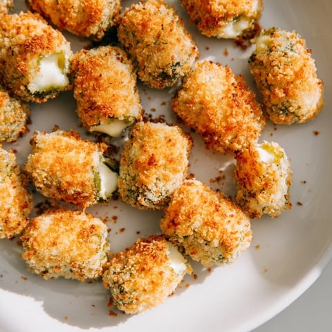 *   Golden-brown Crispy Chickle Bites ready to be devoured, served with a creamy dipping sauce.