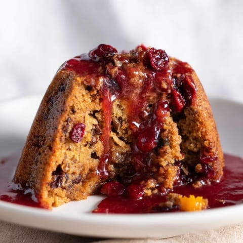 Festive Chestnut Bundt Cake, drizzled with mulled wine glaze and candied orange peel.