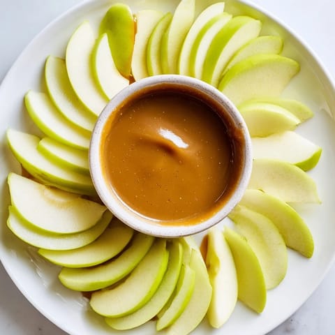 This recipe: Apple Slices with Caramel Dip showcases a platter with arranged, fresh fruit for dipping.