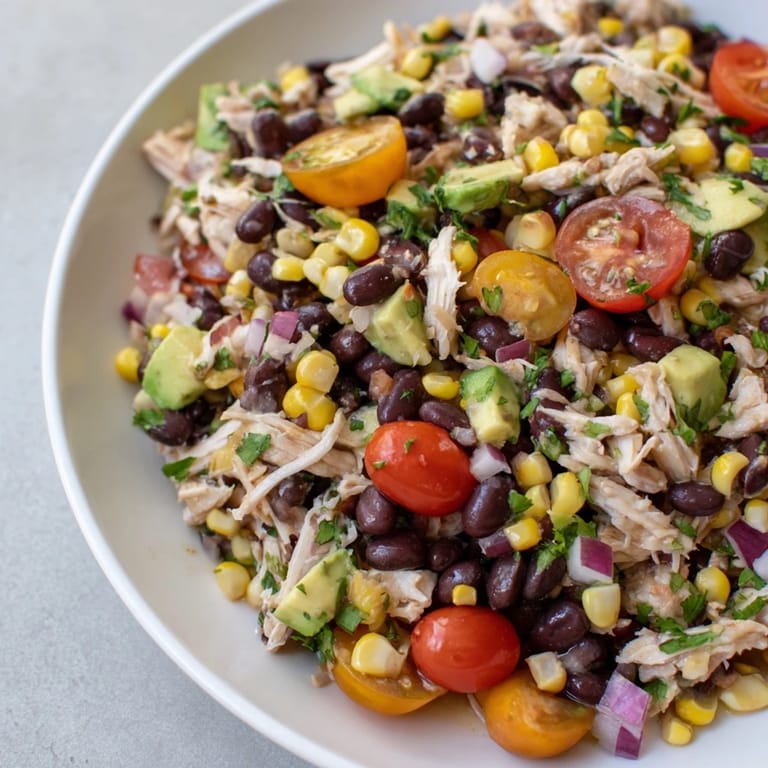 A bowl overflowing with Dense Southwestern Bean Salad, ready to be enjoyed as a hearty side dish.
