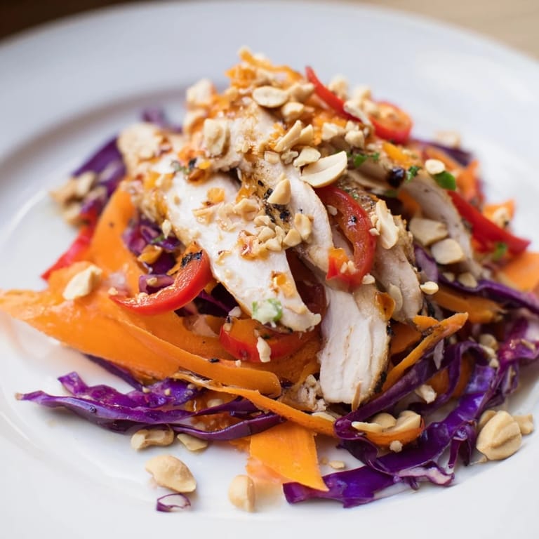This Carrot Ribbon and Chicken Slaw features colorful veggies, juicy chicken, and a zesty miso dressing.