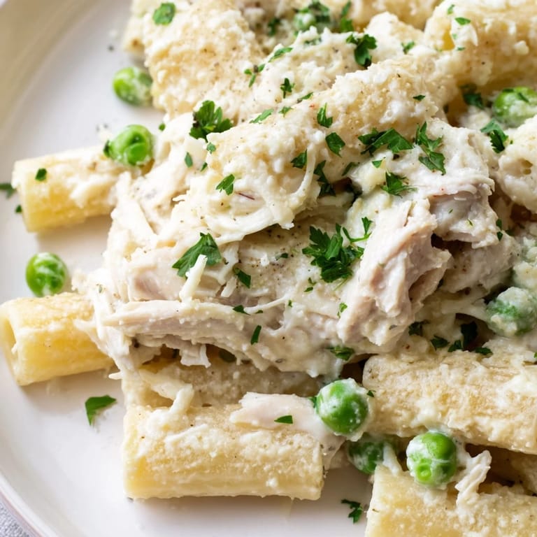 Steaming, creamy Slow Cooker Chicken Alfredo Pasta Bake, perfect comfort food, ready in your crockpot.